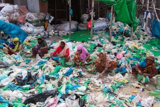 Keraniganj Bangladesh 05 February 2023 View of women sitting on the ground and sorting through piles of colorful plastic waste for recycling at a local facility. Keraniganj Bangladesh 05 February 2023 View of women sitting on the ground and sorting through piles of colorful plastic waste for recycling at a local facility.