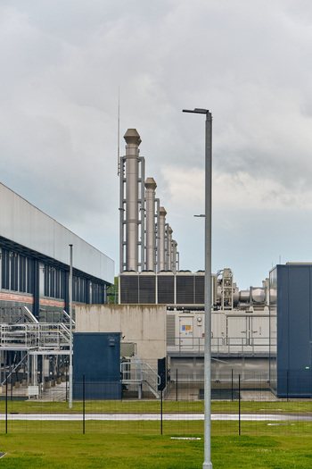 Middenmeer Netherlands 17 May 2026 View of the Microsoft data center facility featuring industrial cooling towers and exhaust stacks under an overcast sky.