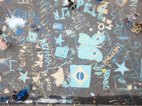 Rio de Janeiro Brazil 13 June 2026 Aerial view of street pavement decorated with colorful chalk drawings of the Brazilian flag and stars for the World Cup 2026 with people.
