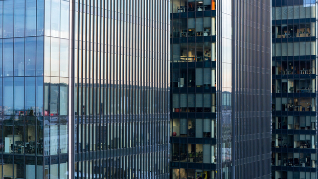 Aerial view of modern glass office skyscrapers with reflective facades and visible interior workspaces in the city center of Gdansk Poland. Aerial view of modern glass office skyscrapers with reflective facades and visible interior workspaces in the city center of Gdansk Poland.