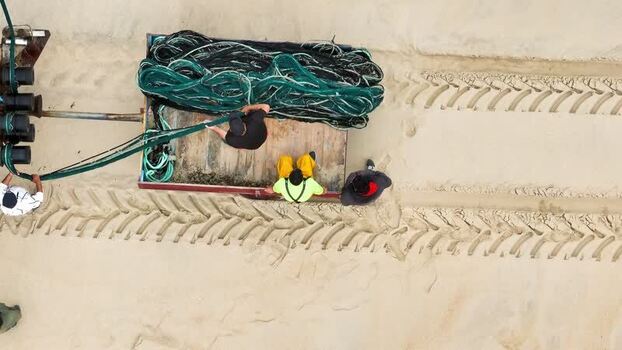 Aerial view of fishermen handling nets on the beach Portugal. Aerial view of fishermen handling nets on the beach Portugal.