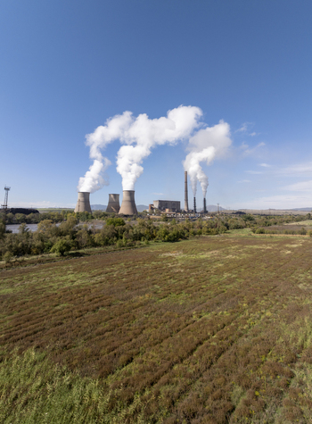 Aerial view of Bobov Dol Power Plant with its cooling towers emitting steam into a clear blue sky over the surrounding fields in Golemo Selo Kyustendil Province Bulgaria. Aerial view of Bobov Dol Power Plant with its cooling towers emitting steam into a clear blue sky over the surrounding fields in Golemo Selo Kyustendil Province Bulgaria.