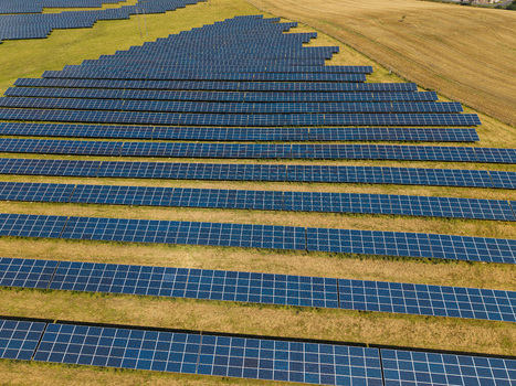 Aerial view of Lisburn Solar Farm featuring rows of photovoltaic panels installed on green fields in Lisburn Northern Ireland United Kingdom. Aerial view of Lisburn Solar Farm featuring rows of photovoltaic panels installed on green fields in Lisburn Northern Ireland United Kingdom.