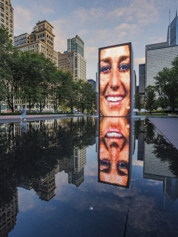 Chicago United States 15 September 2025 View of the Crown Fountain with a digital face display reflected in the water surrounded by skyscrapers and lush trees in Millennium Park.