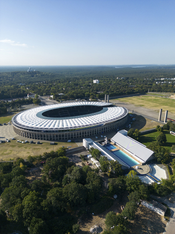 Aerial view of a beautiful urban landscape featuring a stadium and public pools surrounded by greenery and trees Westend Germany.