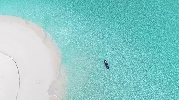 Aerial view of a person on a paddleboard Maldives.