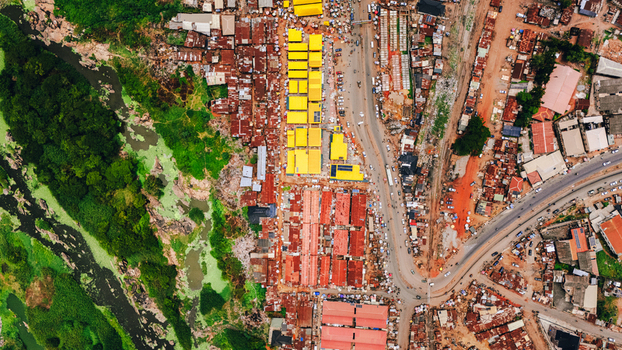 Aerial view of rooftops painted in bright hues of yellow and red contrasting with the earthy tones Abeokuta Ogun State Nigeria.