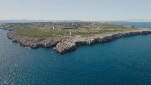 Aerial view of Plemmirio lighthouse and rocky cliffs Italy.