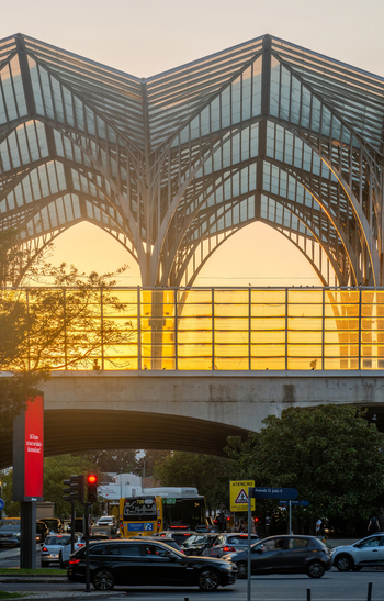 Lisboa Portugal 19 September 2026 View of the Gare do Oriente station with its distinctive vaulted glass roof during sunset featuring traffic on the street below. Lisboa Portugal 19 September 2026 View of the Gare do Oriente station with its distinctive vaulted glass roof during sunset featuring traffic on the street below.