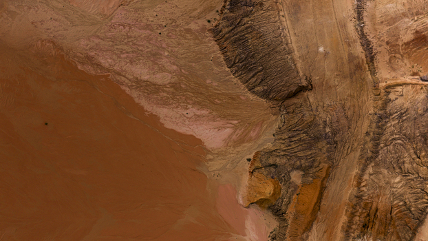 Aerial view of industrial salt mining patterns with sand and earth in brown and yellow tones after a storm near Useless Loop in Kalbarri Western Australia Australia. Aerial view of industrial salt mining patterns with sand and earth in brown and yellow tones after a storm near Useless Loop in Kalbarri Western Australia Australia.