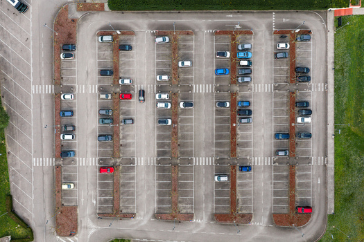 Aerial view of an organized parking lot with parked cars asphalt surface and pedestrian crossings in Leccio Toscana Italy. Aerial view of an organized parking lot with parked cars asphalt surface and pedestrian crossings in Leccio Toscana Italy.