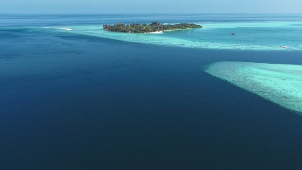 Aerial view of a tropical island and coral reefs Maldives. Aerial view of a tropical island and coral reefs Maldives.