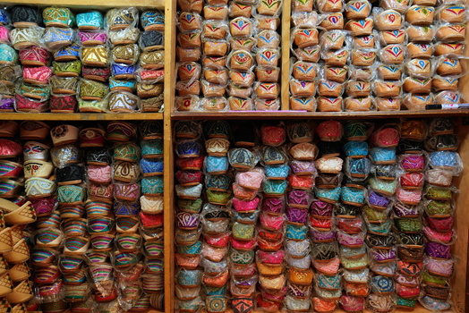View of traditional colorful embroidered shoes neatly arranged on wooden shelves in a local market Dubai Dubai United Arab Emirates. View of traditional colorful embroidered shoes neatly arranged on wooden shelves in a local market Dubai Dubai United Arab Emirates.