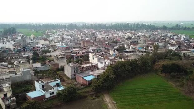 Aerial view of Saidpur village with houses and green fields India.