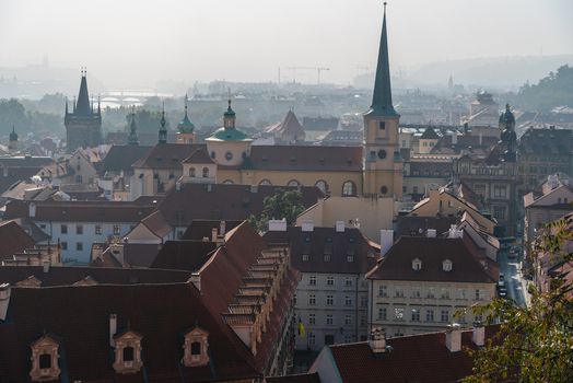 View of the historic skyline of Prague with red tiled rooftops church spires and traditional architecture in Prague Prague Czechia.