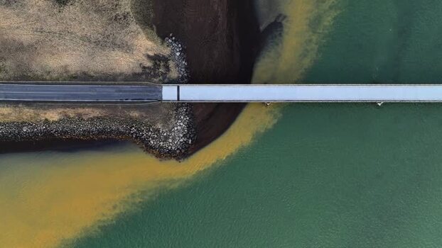 Aerial view of a bridge crossing a silty river Iceland. Aerial view of a bridge crossing a silty river Iceland.