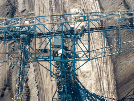 Aerial view of a massive bucket wheel excavator at the Tagebau Welzow Sud brown coal open pit mine showing industrial earthmoving machinery in Spremberg Brandenburg Germany. Aerial view of a massive bucket wheel excavator at the Tagebau Welzow Sud brown coal open pit mine showing industrial earthmoving machinery in Spremberg Brandenburg Germany.