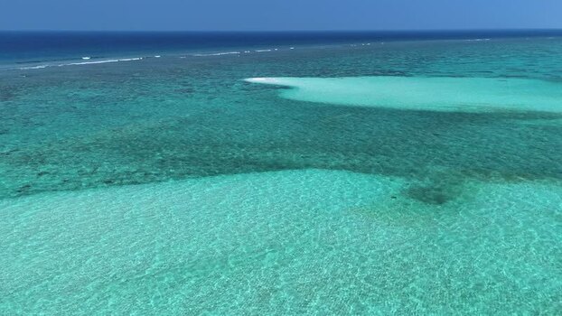 Aerial view of turquoise coral reefs and clear blue ocean water Maldives. Aerial view of turquoise coral reefs and clear blue ocean water Maldives.