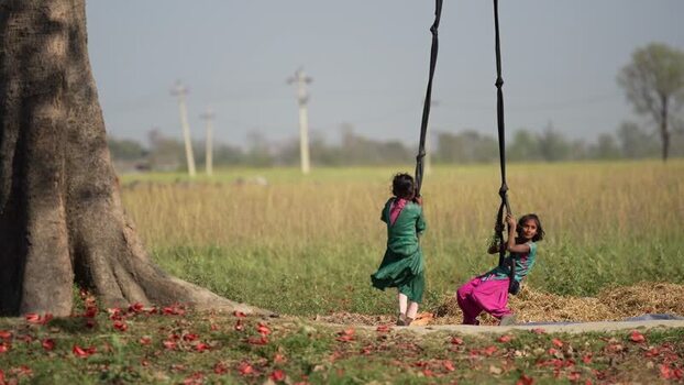 View of children playing on a rope swing in Dhangadhi Nepal.