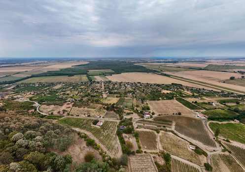 Aerial view of Somlo vineyards and farmland beneath cloudy summer skies across Hungary Aerial view of Somlo vineyards and farmland beneath cloudy summer skies across Hungary