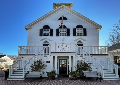 Edgartown United States 14 May 2026 View of Edgartown Town Hall a historic white clapboard building with symmetrical staircases black shutters and an American flag.