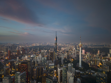 Kuala Lumpur Malaysia 11 March 2026 Aerial view of Merdeka 118 and KL Tower rising above the illuminated city skyline under a twilight sky.