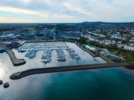 Aerial view of Bangor Harbour and town with numerous boats docked in the marina surrounded by urban buildings and coastal landscape in Bangor Northern Ireland United Kingdom.