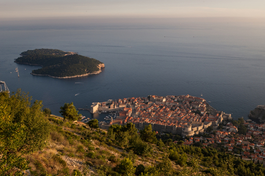 View of the historic Old Town with red tiled roofs and stone walls overlooking the Adriatic Sea and Lokrum Island at sunset Dubrovnik Dubrovnik Neretva County Croatia. View of the historic Old Town with red tiled roofs and stone walls overlooking the Adriatic Sea and Lokrum Island at sunset Dubrovnik Dubrovnik Neretva County Croatia.