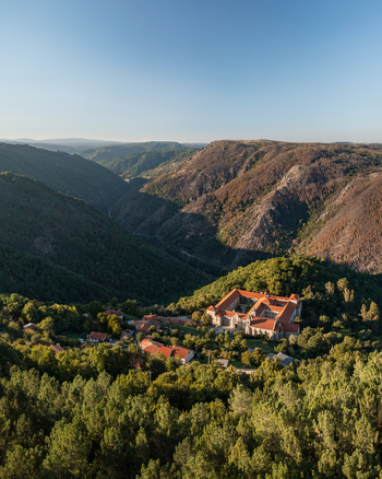 Aerial view of the Monastery of Santo Estevo de Ribas de Sil nestled in the lush green hills of the Ribeira Sacra region O Covelo Ourense Spain.
