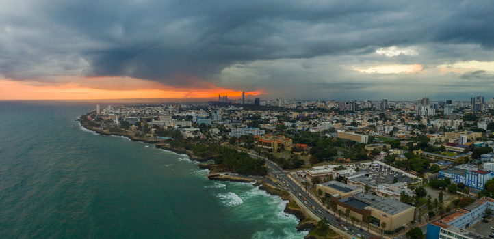 Aerial view of the Centro De Los Heroes area and the Santo Domingo coastline under dramatic sunset clouds along the Caribbean Sea in Santo Domingo Distrito Nacional Dominican Republic.