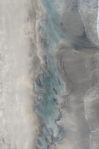 Aerial view of the intricate sand patterns and tidal pools on the beach of Senja Troms Norway.