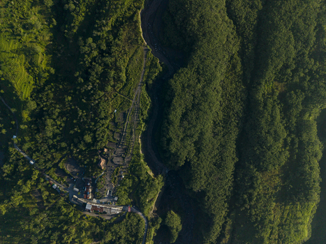 Aerial view of Bunker Kaliadem Merapi surrounded by dense tropical forest and a deep river valley in Kecamatan Pakem Daerah Istimewa Yogya Indonesia. Aerial view of Bunker Kaliadem Merapi surrounded by dense tropical forest and a deep river valley in Kecamatan Pakem Daerah Istimewa Yogya Indonesia.
