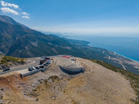 Aerial view of Bregdet.al Llogara Pass with a scenic observation deck parked cars and a panoramic view of the coastline and mountains in Llogara Vlore County Albania. Aerial view of Bregdet.al Llogara Pass with a scenic observation deck parked cars and a panoramic view of the coastline and mountains in Llogara Vlore County Albania.
