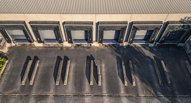 Aerial view of warehouse loading dock doors at a modern logistics center in Le Pouzin Auvergne Rhone Alpes France.