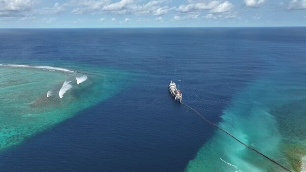 Aerial view of a dredger near a coral reef in Gulhi Maldives.