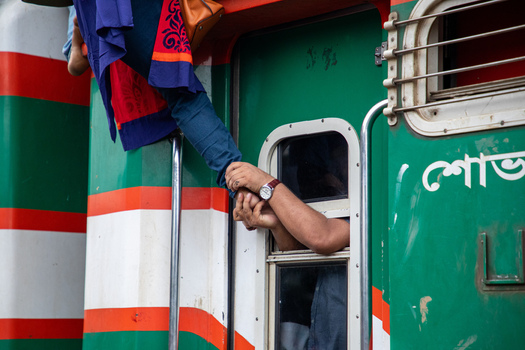 Dhaka Bangladesh 15 June 2018 View of hands reaching out from a train window to help a passenger climb aboard at Airport Railway Station. Dhaka Bangladesh 15 June 2018 View of hands reaching out from a train window to help a passenger climb aboard at Airport Railway Station.