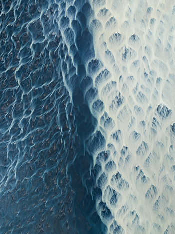 Aerial view of braided rivers carving through the stark contrasting landscape a dance of icy blues and pale whites creating an otherworldly spectacle Iceland Iceland. Aerial view of braided rivers carving through the stark contrasting landscape a dance of icy blues and pale whites creating an otherworldly spectacle Iceland Iceland.