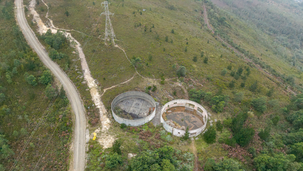 Aerial view of the Outeniqua Pass with circular concrete ruins an electricity pylon and a dirt road Garden Route District Municipality Western Cape South Africa.