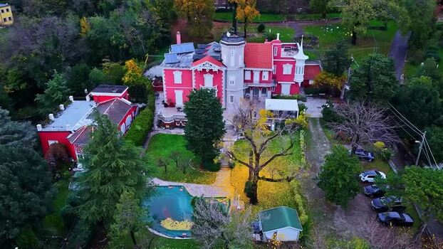 Aerial View of a Vibrant Red Villa in Italy