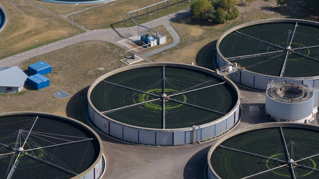 Aerial view of Klarwerk Karlsruhe sewage treatment plant with large circular sedimentation tanks and industrial infrastructure in Karlsruhe Baden Wurttemberg Germany.