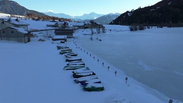 Aerial view of snow covered boats on frozen Lake Reschen Italy. Aerial view of snow covered boats on frozen Lake Reschen Italy.
