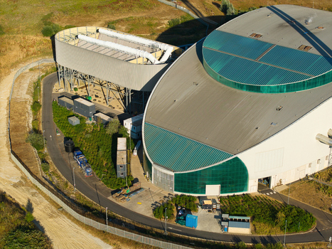 Aerial view of the Energy Recovery Facility a biomass to electricity plant with a large curved roof and industrial ventilation systems in Bicester England United Kingdom.