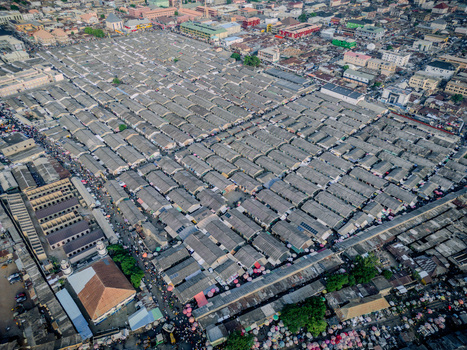 Aerial view of the central market featuring dense rows of grey roofed stalls and bustling crowds in Kaduna Kaduna Nigeria. Aerial view of the central market featuring dense rows of grey roofed stalls and bustling crowds in Kaduna Kaduna Nigeria.