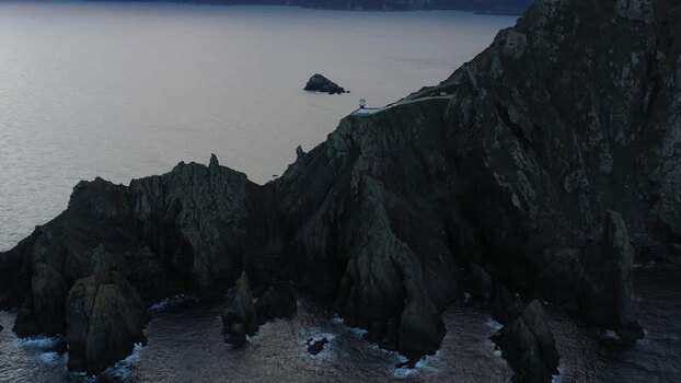 Aerial view of Faro do Cabo Ortegal lighthouse on cliffs Spain.