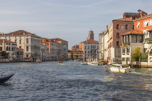 View of the Grand Canal in Venice featuring historic palazzos traditional boats and water taxis on a sunny day in Venice Veneto Italy. View of the Grand Canal in Venice featuring historic palazzos traditional boats and water taxis on a sunny day in Venice Veneto Italy.