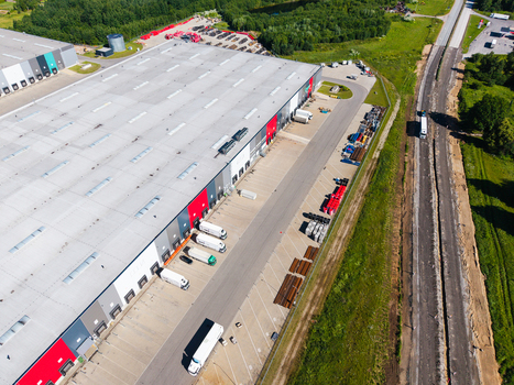 Lielvarzi Latvia 05 July 2026 Aerial view of VGP Park Kekava Warehouse featuring a large industrial facility with loading docks parked semi trucks and surrounding green landscape. Lielvarzi Latvia 05 July 2026 Aerial view of VGP Park Kekava Warehouse featuring a large industrial facility with loading docks parked semi trucks and surrounding green landscape.