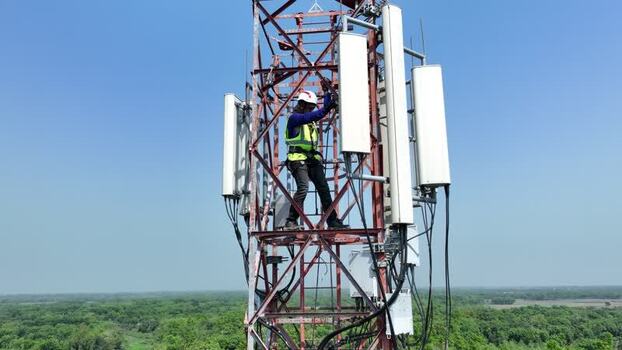 Aerial view of a technician on a telecommunications tower Bangladesh.