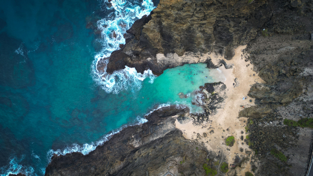 Aerial view of where the turquoise ocean embraces the rugged dark cliffs near Koko Head volcano painting a vivid contrast of nature s raw power and serene beauty Honolulu Hawaii United States. Aerial view of where the turquoise ocean embraces the rugged dark cliffs near Koko Head volcano painting a vivid contrast of nature s raw power and serene beauty Honolulu Hawaii United States.