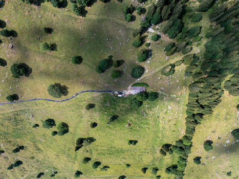Aerial view of the Justistal valley near Niederhorn with a small mountain hut winding dirt paths scattered trees and lush green alpine meadows in Sigriswil Bern Switzerland. Aerial view of the Justistal valley near Niederhorn with a small mountain hut winding dirt paths scattered trees and lush green alpine meadows in Sigriswil Bern Switzerland.