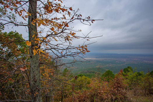 View of autumn colors paint the Ozark Mountains under a cloudy sky revealing nature s beauty a scenic vista of Arkansas s natural landscape Magazine Arkansas United States. View of autumn colors paint the Ozark Mountains under a cloudy sky revealing nature s beauty a scenic vista of Arkansas s natural landscape Magazine Arkansas United States.